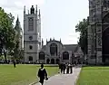 St Margaret's Church. To the left is the Elizabeth Tower of the Palace of Westminster; to the right is the Abbey.