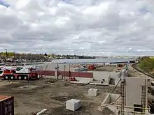 A construction site with low concrete walls in place