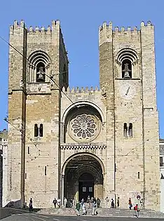 Lisbon Cathedral, Portugal, 1147, has a similar form to the Old Cathedral of Coimbra above with the addition of two sturdy bell towers in the Norman manner and a wheel window.