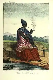 Image 9The Queen of Waalo - Lingeer Ndaté Yalla Mbodj (1810–1860) in her royal dress, seating and smoking a pipe.Credit: Llanta. Lithographer, Abbot P. David Boilat, author of text in his book Esquisses sénégalaises (1853). Source: cote : Gallica, bnf.fr - Réserve DT 549.2 B 67 M Atlas - planche n °5 - Notice n° : FRBNF38495418 - (Illustrations de Esquisses sénégalaises). Uploader to Wiki Commons   Patricia.fidiMore about Ndaté Yalla Mbodj...