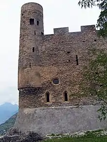 Small round tower in the corner of a wall. The bottom of the tower merges with the corner.