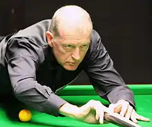  Steve Davis playing a shot with the rest