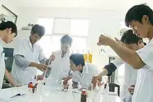 Vietnamese science students working on an experiment in their university lab.