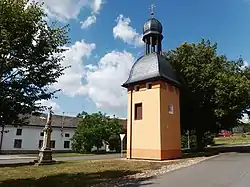 Centre of Tučín with a statue of the Virgin Mary and a belfry