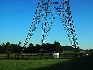 Antenna tuning hut under a radio tower.