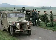 Members of the 11th Armored Cavalry stop to talk with West German border police while patrolling the border between East and West Germany in M151 light vehicles