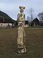 Wooden carved sculpture at the entrance to the village