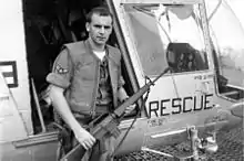 A1C William Pitsenbarger in front of an HH-43 Huskie