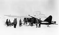 Wop May loads his airplane at Aklavik.