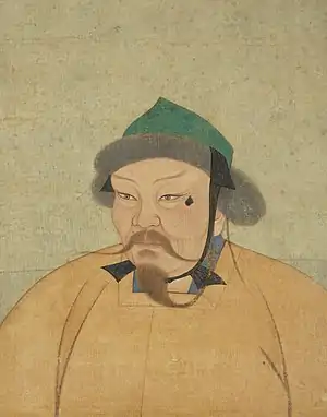 A portrait of a Mongol man wearing an orange robe and a pointed green cap; his mustache and beard are long and thin.