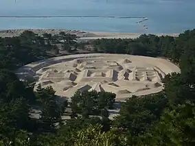 The coin-shaped sand-drawing" or Zenigata suna-e (銭形砂絵) based on the Japanese Kan'ei Tsūhō (寛永通寳) cash coins whose origins date back to 1633 in the Kotohiki Park which lies in Kan'onji, Kagawa Prefecture.